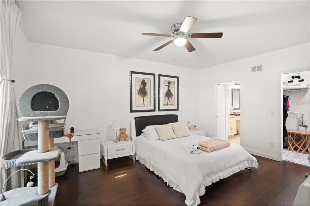 248 Longhirst Loop Ocoee, FL 34761 - Photo 10 of 30 a bedroom with a bed and a large window