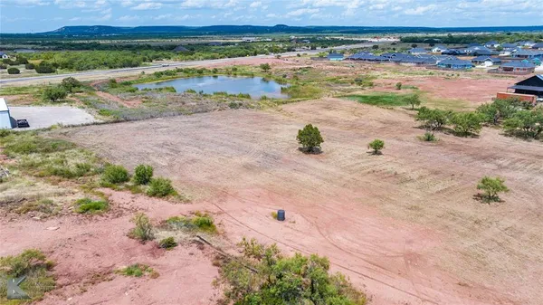 an aerial view of a houses with a yard