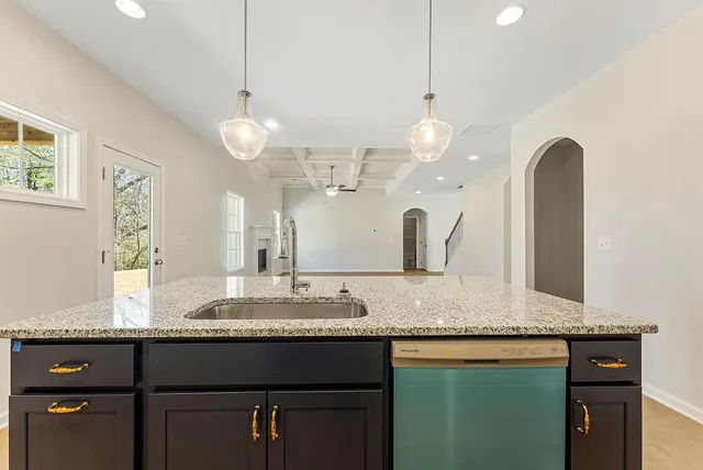 a bathroom with a granite countertop double vanity sink and a mirror