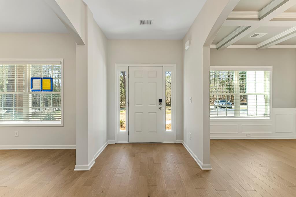 515 Bohannon Road Grantville, GA 30220 - Photo 2 of 40 an empty room with wooden floor and windows