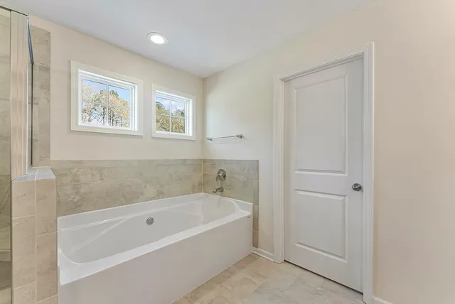 a white bath tub sitting next to a window