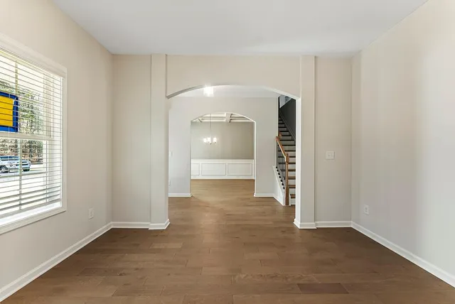 an empty room with windows and entrance