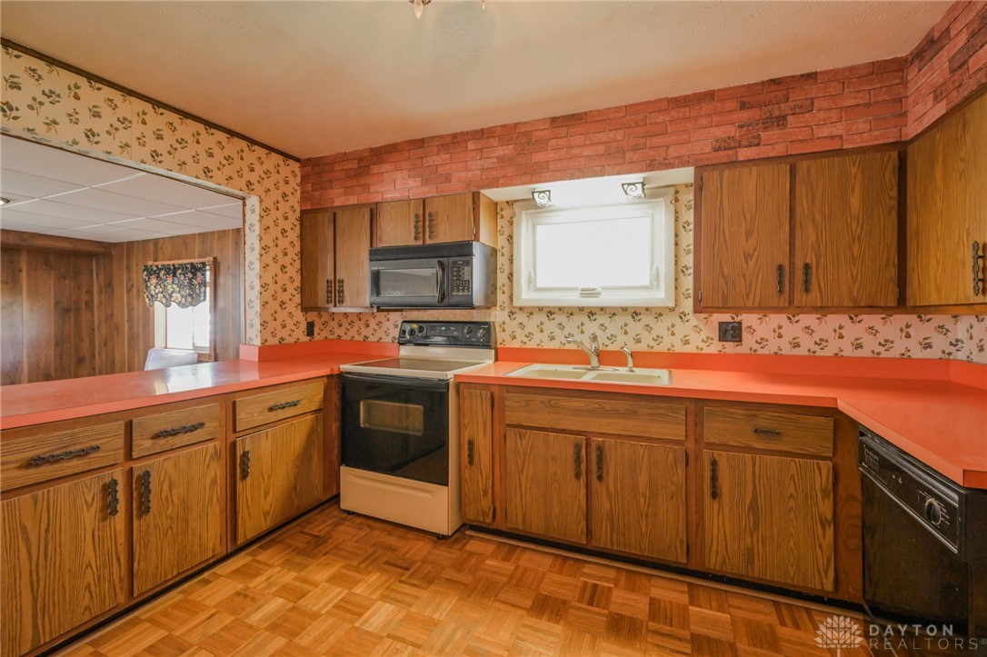 3057 Springfield Xenia Road Springfield, OH 45506 - Photo 12 of 37 This kitchen offers a warm and inviting space, perfect for culinary endeavors.