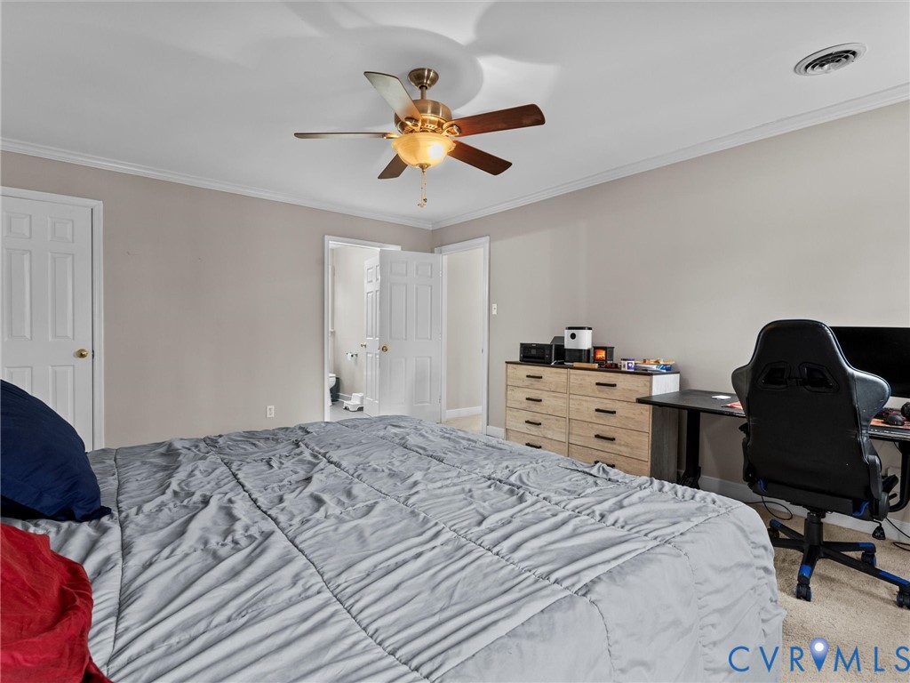 5813 Bent Creek Road Midlothian, VA 23112 - Photo 30 of 50 a bedroom with a bed and a chandelier