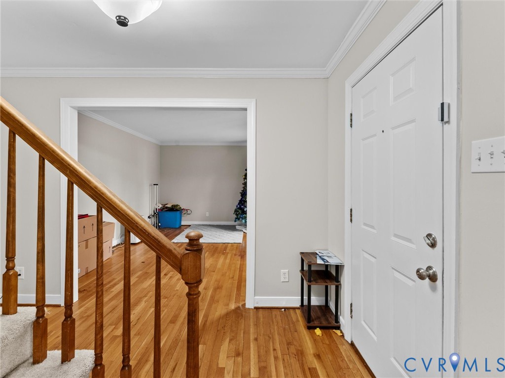 5813 Bent Creek Road Midlothian, VA 23112 - Photo 4 of 50 a view of a hallway with wooden floor and staircase