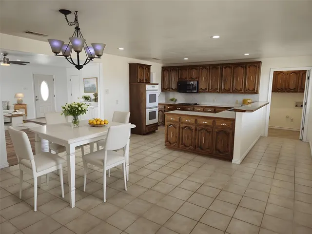 a kitchen with stainless steel appliances granite countertop a sink a stove and a refrigerator