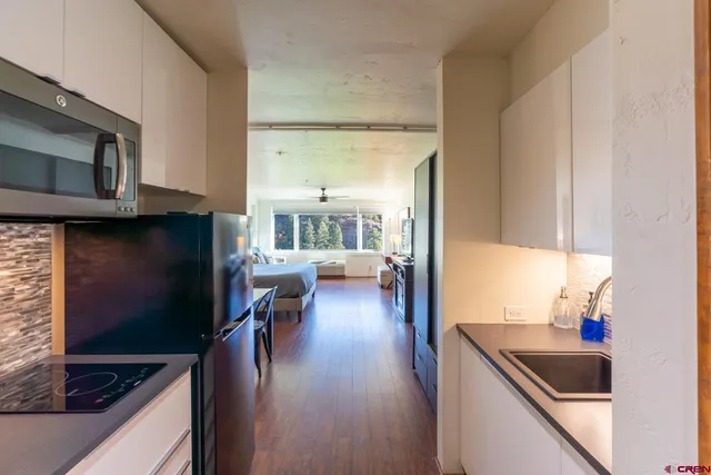 a kitchen with a sink a counter top space and cabinets