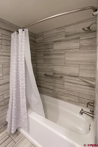 a bathroom with a shower and a bathtub