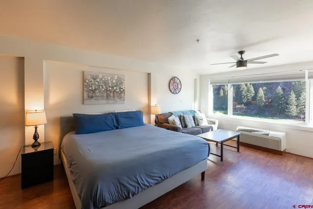 a bedroom with a bed and window