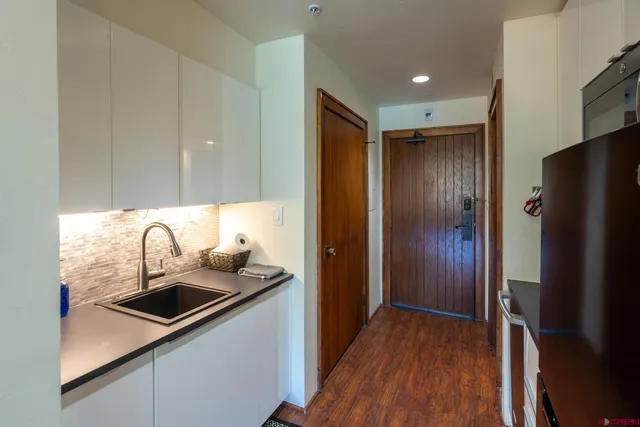 a kitchen with stainless steel appliances a sink stove and refrigerator