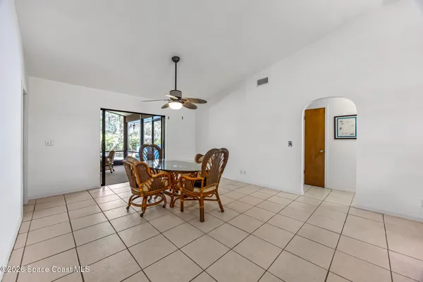 a yellow building with trees in front of it