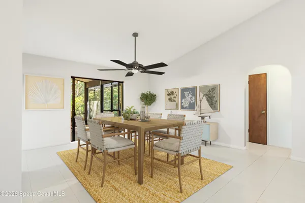 a backyard of a house with table and chairs under an umbrella