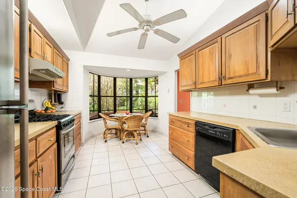 a view of a patio with table and chairs under an umbrella