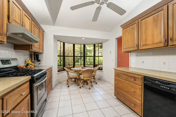 a view of a yard with plants and trees