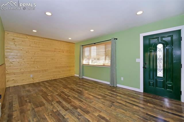 1914 Wooten Road Colorado Springs, CO 80915 - Photo 9 of 39 Entryway with wooden walls, dark wood finished floors, and recessed lighting