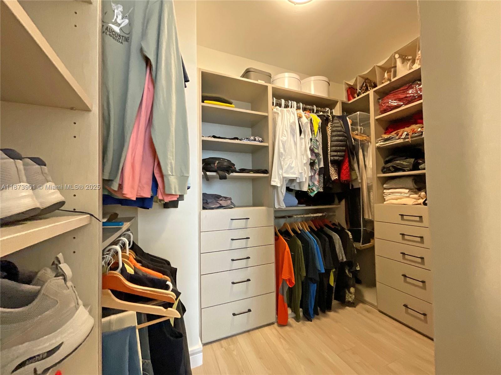 20191 East Country Club Drive, Unit 1903 Aventura, FL 33180 - Photo 11 of 19 a view of walk in closet with clothes and shoes