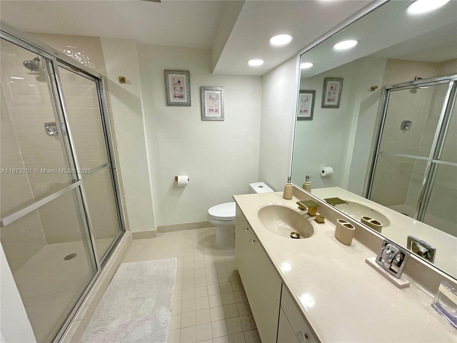 20191 East Country Club Drive, Unit 1903 Aventura, FL 33180 - Photo 15 of 19 a bathroom with a sink a toilet and shower