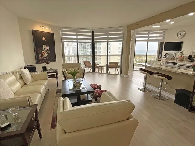 a living room with furniture and large windows