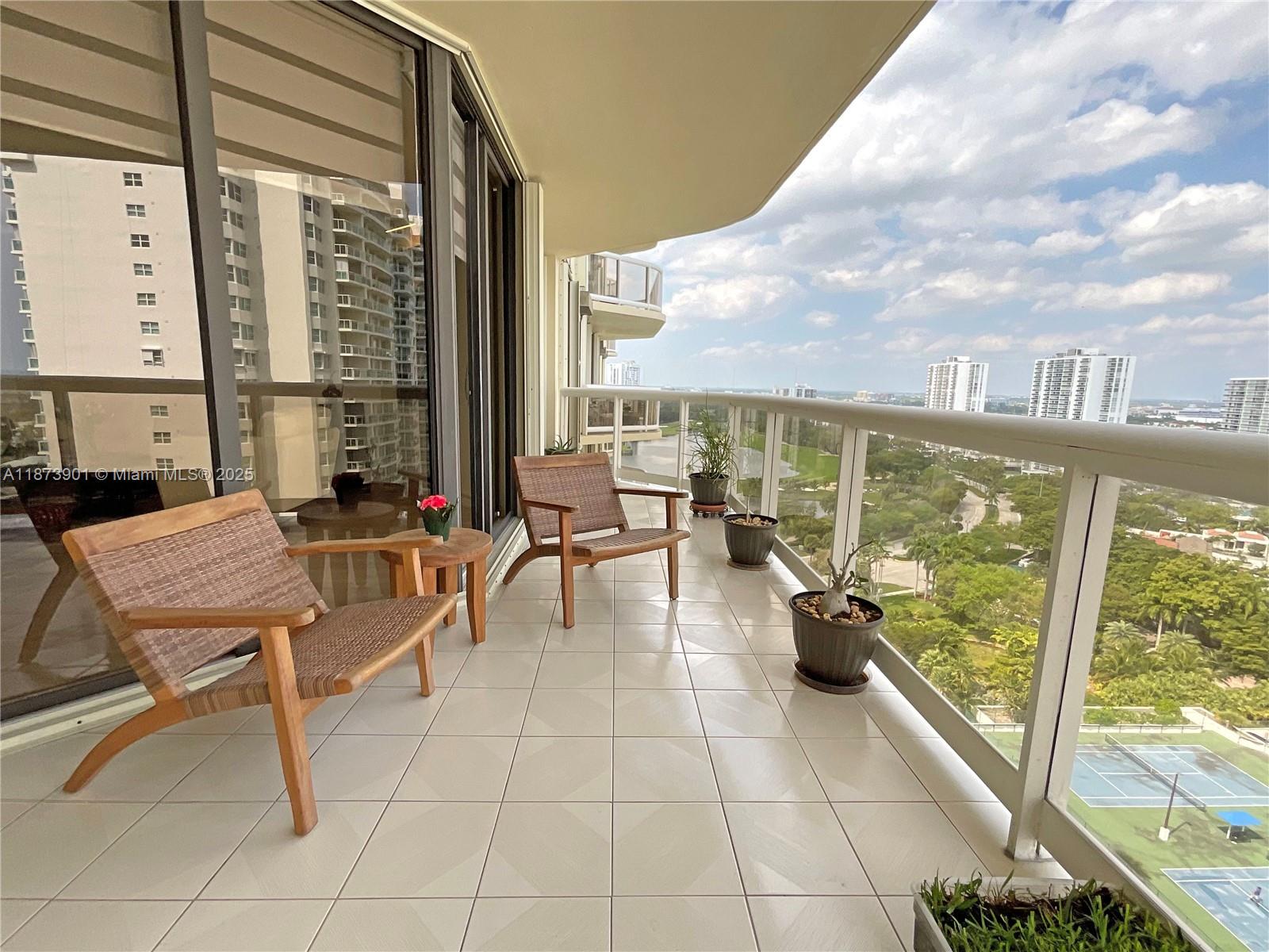 20191 East Country Club Drive, Unit 1903 Aventura, FL 33180 - Photo 4 of 19 a lobby with furniture and floor to ceiling windows