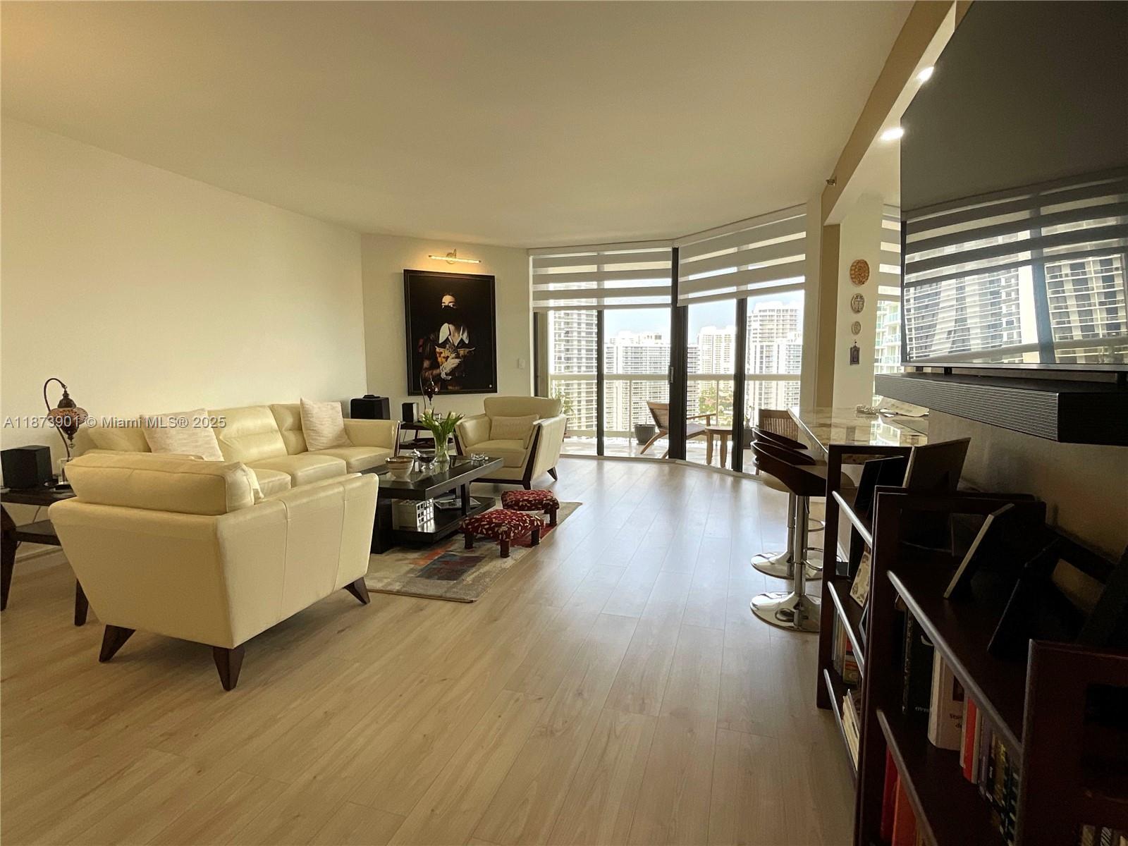 20191 East Country Club Drive, Unit 1903 Aventura, FL 33180 - Photo 9 of 19 a living room with furniture floor to ceiling window and wooden floor