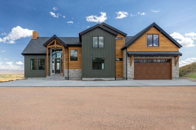 300 Knoll Loop, Unit 227 Fish Haven, ID 83287 - Photo 1 of 56 View of front of home featuring board and batten siding, stone siding, concrete driveway, and a chimney