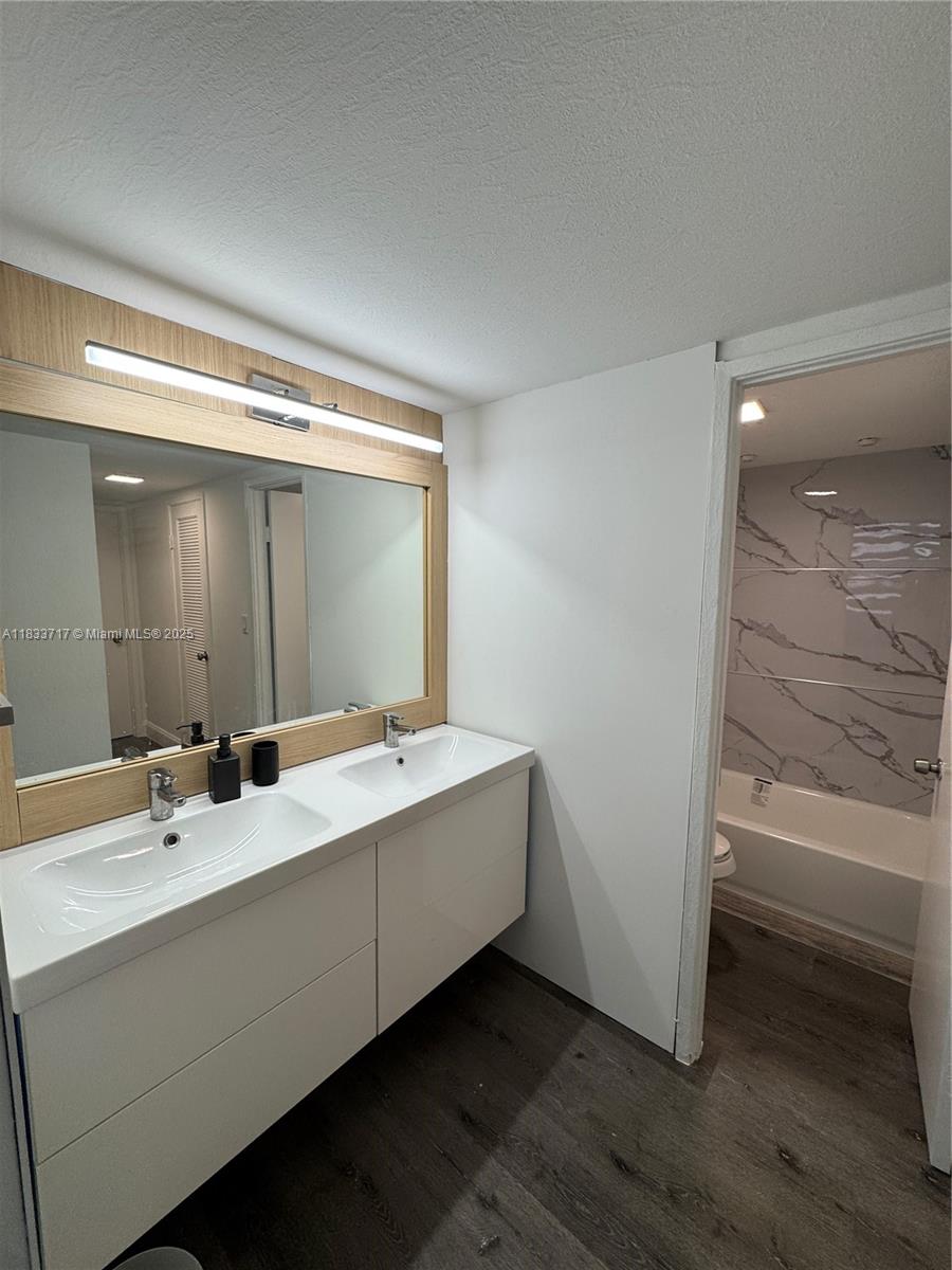 Buckley Towers Miami, FL 33179 - Photo 11 of 18 a bathroom with a double vanity sink and mirror
