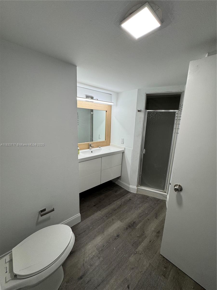 Buckley Towers Miami, FL 33179 - Photo 13 of 18 a bathroom with a toilet a sink and mirror