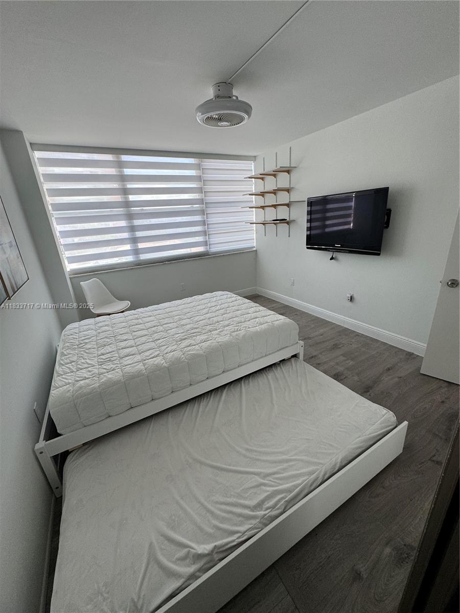 Buckley Towers Miami, FL 33179 - Photo 14 of 18 a bedroom with a bed and a window