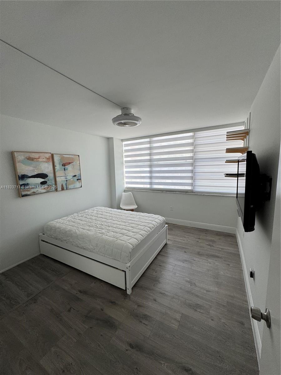 Buckley Towers Miami, FL 33179 - Photo 15 of 18 a bedroom with a bed a window and dresser