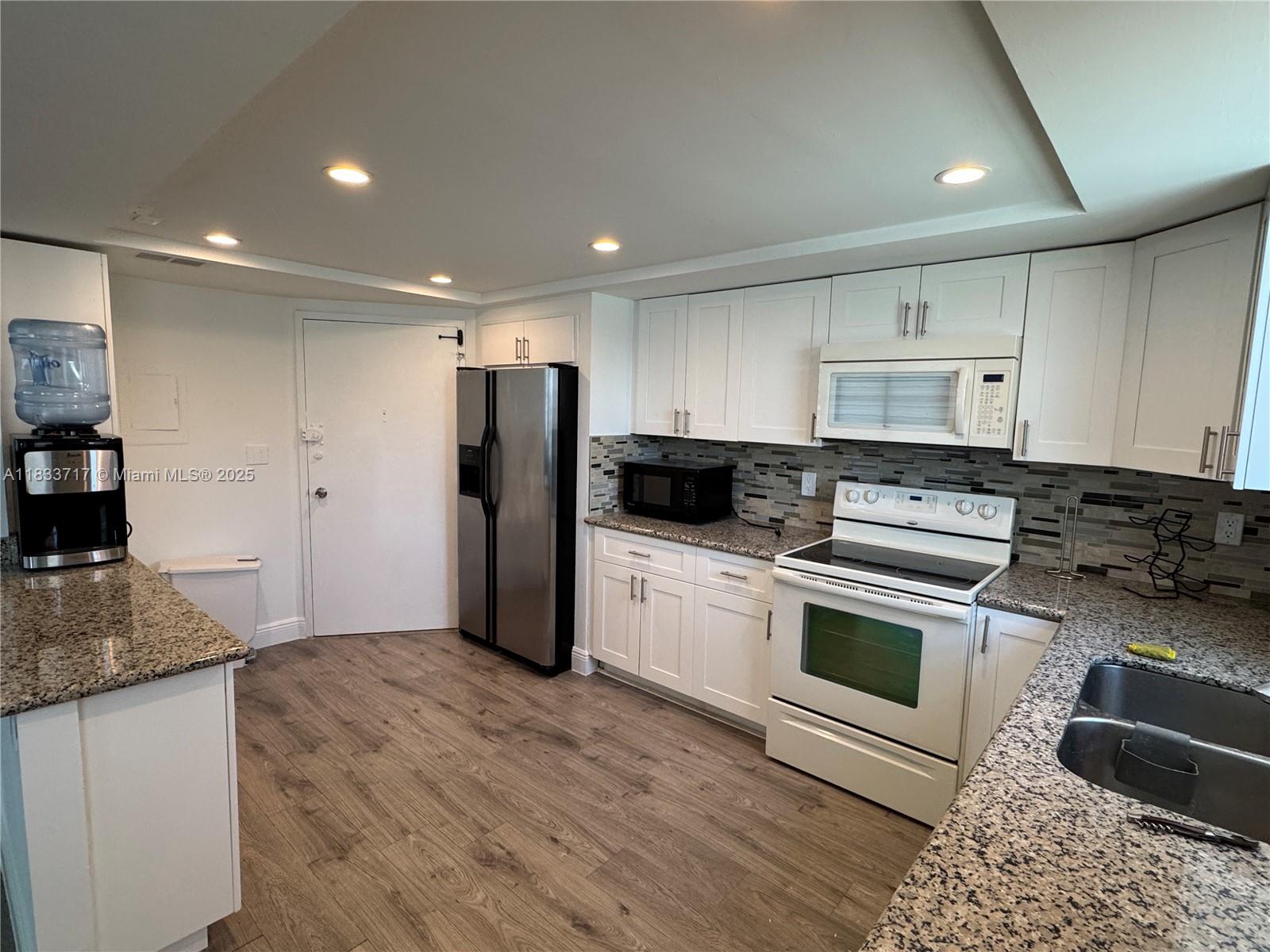 Buckley Towers Miami, FL 33179 - Photo 5 of 18 a kitchen with stainless steel appliances granite countertop a stove a sink and a refrigerator