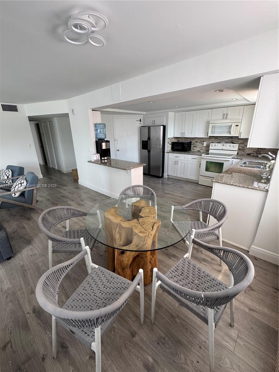 Buckley Towers Miami, FL 33179 - Photo 6 of 18 a living room with couches chairs and kitchen view