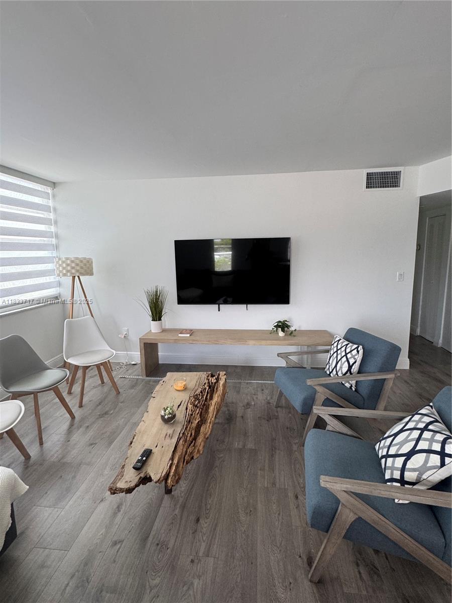 Buckley Towers Miami, FL 33179 - Photo 8 of 18 a living room with furniture and a flat screen tv