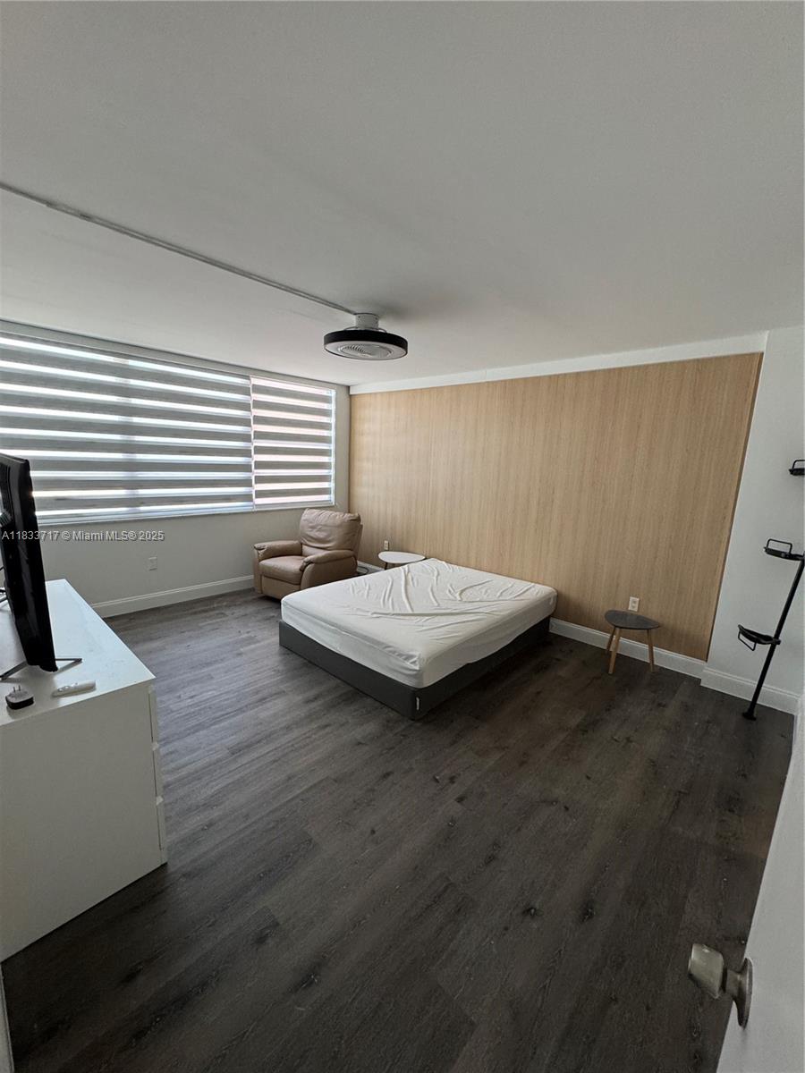 Buckley Towers Miami, FL 33179 - Photo 10 of 18 a bedroom with a bed and wooden floor