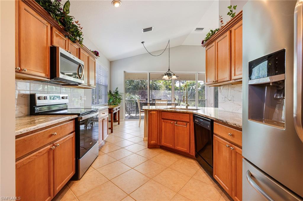 19081 Ridgepoint Drive, Unit 201 Estero, FL 33928 - Photo 5 of 42 a kitchen with stainless steel appliances granite countertop a sink and cabinets