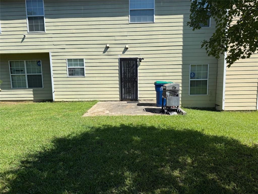 6782 Mancha Street Atlanta, GA 30349 - Photo 2 of 2 a view of a house with backyard and a tree
