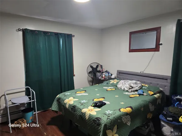 a bed sitting in a bedroom next to a window