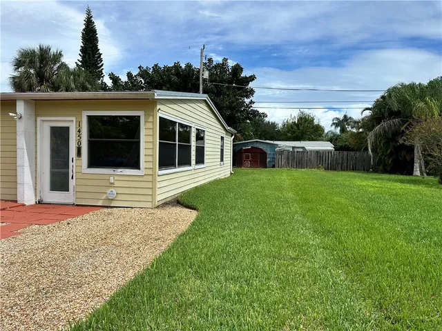 a view of a house with a backyard