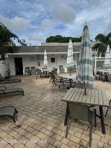 a front view of a house with a garden and yard