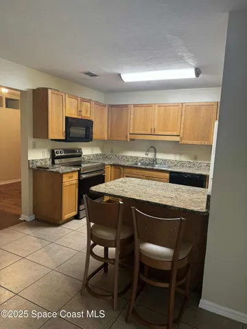 a kitchen with a sink cabinets and window