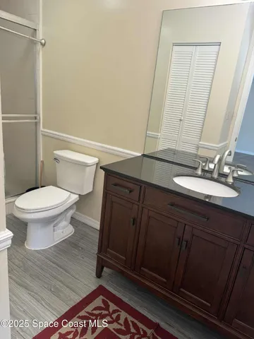 a bathroom with a sink a toilet and a mirror