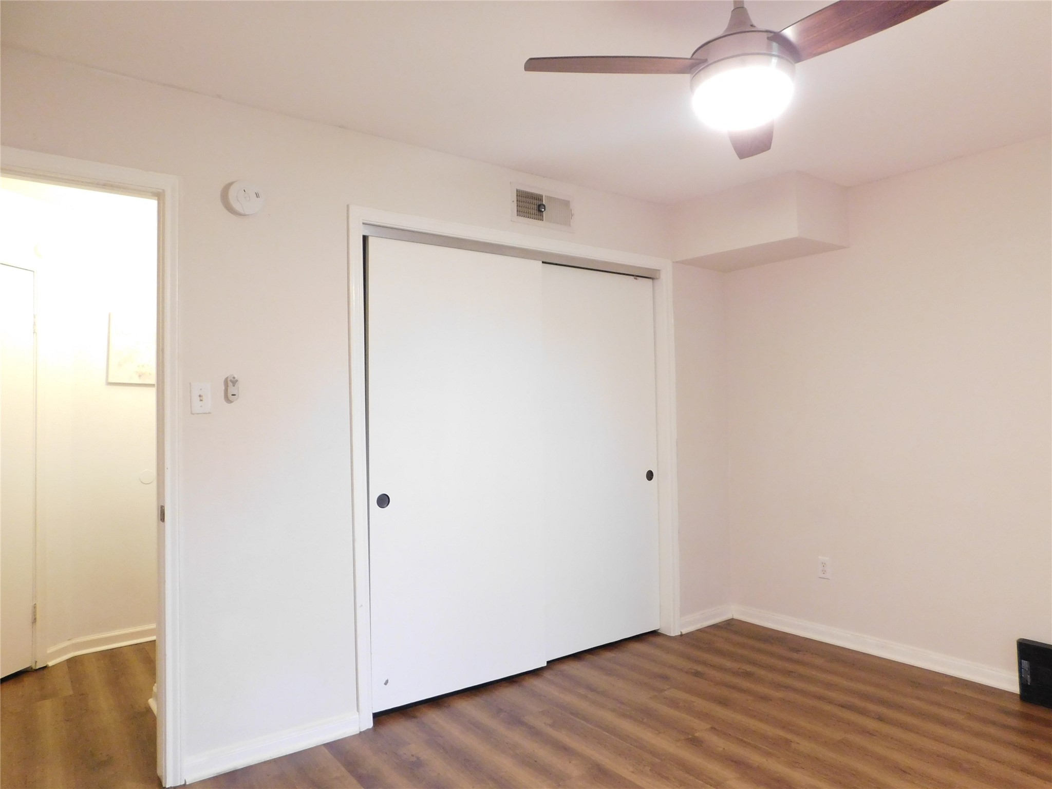 10101 South Gessner Road, Unit 912 Houston, TX 77071 - Photo 29 of 47 a view of an empty room with wooden floor