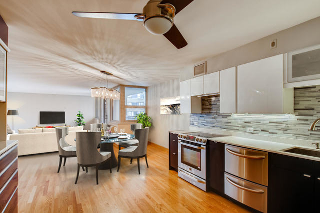6147 North Sheridan Road, Unit 16A Chicago, IL 60660 - Photo 13 of 30 a open kitchen with stainless steel appliances granite countertop a stove and a wooden floors
