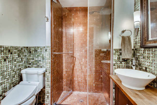 6147 North Sheridan Road, Unit 16A Chicago, IL 60660 - Photo 22 of 30 a bathroom with a granite countertop sink toilet and shower