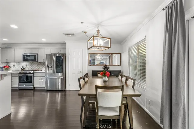 a kitchen with microwave a stove and wooden floor