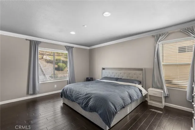 a bed sitting in a bedroom next to a window