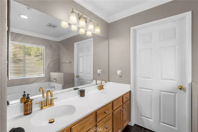a bathroom with a sink double vanity and a mirror