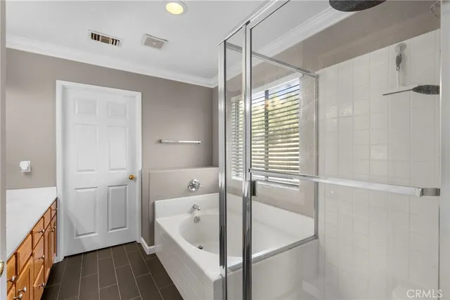 a bathroom with a tub shower and sink
