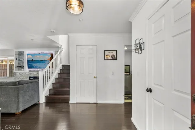 a view of entryway and hall with wooden floor