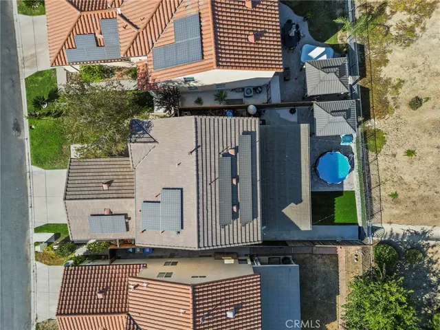 a view of a brick house with many windows and plants