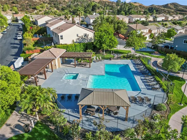 an aerial view of a house with swimming pool trees and outdoor seating